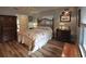 Charming bedroom featuring hardwood floors, comfortable bedding, and warm lighting at 1308 63Rd Nw St, Bradenton, FL 34209
