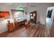 Bright bedroom featuring a wooden desk, armoire, and modern wood-look flooring at 1308 63Rd Nw St, Bradenton, FL 34209