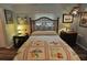 Cozy bedroom with wood-framed bed, side tables with lamps, and warm-toned decor at 1308 63Rd Nw St, Bradenton, FL 34209