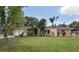Charming single-story home featuring a well-manicured lawn, lush landscaping, and an attached garage at 1308 63Rd Nw St, Bradenton, FL 34209