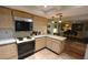 Functional kitchen area with wood cabinets, tile floors, and modern appliances at 1308 63Rd Nw St, Bradenton, FL 34209