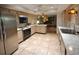 Well-lit kitchen featuring tile flooring, stainless steel appliances, and ample counter space at 1308 63Rd Nw St, Bradenton, FL 34209