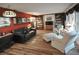 Spacious living room with hardwood floors, custom bookshelves, and ample seating at 1308 63Rd Nw St, Bradenton, FL 34209