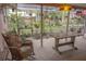 Enclosed patio with a table, chairs, and a view of the lush greenery at 1308 63Rd Nw St, Bradenton, FL 34209