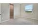 Carpeted bedroom with neutral walls and a walk-in closet offers a calm, private space at 13908 Painted Loop, Parrish, FL 34219