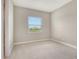 This bedroom is carpeted, features a window and fresh neutral paint, and has an ensuite walk-in closet at 13908 Painted Loop, Parrish, FL 34219