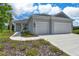 Beautiful single-story home with a manicured lawn, two car garage and covered entryway at 13908 Painted Loop, Parrish, FL 34219