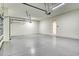 This spacious garage offers ample room for parking and storage with its clean, sealed concrete floors at 13908 Painted Loop, Parrish, FL 34219