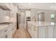 Gourmet kitchen with white cabinets, stainless appliances, and marble countertops at 13908 Painted Loop, Parrish, FL 34219