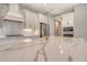 Close-up of kitchen island featuring marble countertop, gold faucet, and stainless appliances at 13908 Painted Loop, Parrish, FL 34219