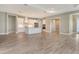 Open-concept kitchen and living area with wood-look tile flooring at 13908 Painted Loop, Parrish, FL 34219
