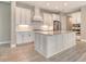 Modern kitchen boasts white cabinetry, stainless steel appliances, and marble countertops at 13908 Painted Loop, Parrish, FL 34219