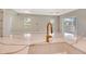 Close-up of kitchen island with marble countertops and gold faucet overlooking open living space at 13908 Painted Loop, Parrish, FL 34219