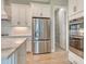 Kitchen features stainless steel appliances, white cabinets, and walk-in pantry access at 13908 Painted Loop, Parrish, FL 34219