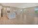 Open-concept kitchen and living area with a center island and stainless steel appliances at 13908 Painted Loop, Parrish, FL 34219