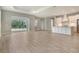 Spacious living area showcasing tile flooring and an open layout with access to the kitchen and outdoor space at 13908 Painted Loop, Parrish, FL 34219