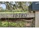 Close-up of a rustic wooden address sign displaying the house number '15780' at 15780 Wilson Rd, Sarasota, FL 34240