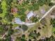 Estate featuring a house, barn, pool, and additional buildings, showcasing a comprehensive property layout at 15780 Wilson Rd, Sarasota, FL 34240