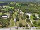 A sprawling countryside estate featuring multiple buildings and structures on a vast, green property at 15780 Wilson Rd, Sarasota, FL 34240
