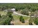 Expansive property with mature trees, featuring a home with a long driveway in a peaceful, wooded setting at 15780 Wilson Rd, Sarasota, FL 34240