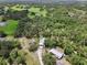 A charming estate with multiple structures surrounded by lush greenery, featuring an in-ground pool at 15780 Wilson Rd, Sarasota, FL 34240