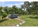 View of the backyard featuring above-ground pool, grass, and a mature tree at 15780 Wilson Rd, Sarasota, FL 34240