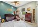 The baby's room features a crib, chair, changing table, and gray and teal walls at 15780 Wilson Rd, Sarasota, FL 34240