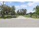 A gravel driveway leading to a residential property with a fenced yard at 15780 Wilson Rd, Sarasota, FL 34240
