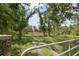 Gated driveway through a wooded area providing a private entrance to the property at 15780 Wilson Rd, Sarasota, FL 34240