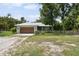 Charming single-story home featuring a metal roof and well-maintained front yard with a wooden fence at 15780 Wilson Rd, Sarasota, FL 34240