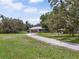Lovely home with a well-maintained lawn and a long driveway leading to the attached garage at 15780 Wilson Rd, Sarasota, FL 34240