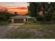 Inviting home with a beautiful sunset backdrop, lush landscaping, and a cozy curb appeal at 15780 Wilson Rd, Sarasota, FL 34240