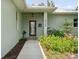 The front of the house is decorated with nice landscaping and a welcoming front door with a welcome sign at 15780 Wilson Rd, Sarasota, FL 34240