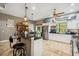 Bright kitchen featuring an island with granite countertops, stainless steel fridge, and modern cabinets at 15780 Wilson Rd, Sarasota, FL 34240
