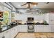Cozy kitchen featuring granite countertops, stainless steel appliances, and white cabinets with decor at 15780 Wilson Rd, Sarasota, FL 34240