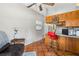 Cozy kitchenette features wood cabinets, a breakfast bar with seating and plenty of natural light at 15780 Wilson Rd, Sarasota, FL 34240