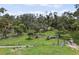 A beautiful plot of land with mature trees, fencing, and a well-maintained green field at 15780 Wilson Rd, Sarasota, FL 34240