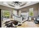 Relaxing primary bedroom features neutral paint, a tray ceiling, a sliding glass door, and an en-suite bathroom at 15780 Wilson Rd, Sarasota, FL 34240