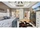 Spacious main bedroom with a tray ceiling, barn door to the bathroom, and a large bed at 15780 Wilson Rd, Sarasota, FL 34240