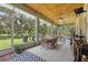 Spacious screened patio with outdoor seating, tiled flooring, and views of the lush backyard at 15780 Wilson Rd, Sarasota, FL 34240