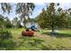 Charming backyard playhouse elevated with stairs, slide, and swing set for fun and outdoor activities at 15780 Wilson Rd, Sarasota, FL 34240