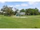 Wonderful backyard with a charming, elevated playhouse, slide, and swing set for outdoor enjoyment at 15780 Wilson Rd, Sarasota, FL 34240
