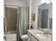Well-lit bathroom with granite countertops, tile shower, and tasteful decor at 16087 Sunny Day Dr, Bradenton, FL 34211