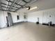 Clean, spacious garage with epoxy flooring, insulated doors, and ample storage space at 16087 Sunny Day Dr, Bradenton, FL 34211