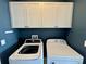 Functional laundry area with overhead cabinets and side-by-side washer and dryer at 16087 Sunny Day Dr, Bradenton, FL 34211