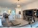 Inviting living room with a modern entertainment center, open layout, and seamless flow into the dining area at 16087 Sunny Day Dr, Bradenton, FL 34211