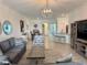 Comfortable living room with stylish furniture, bright lighting, and an open layout connecting to other living spaces at 16087 Sunny Day Dr, Bradenton, FL 34211