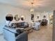 Bright living room featuring stylish furnishings and elegant decor, open to the dining area for easy entertaining at 16087 Sunny Day Dr, Bradenton, FL 34211