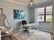 Bright office space with a modern desk, a comfortable chair, and stylish hanging chair at 16087 Sunny Day Dr, Bradenton, FL 34211