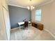 Comfortable office featuring a sleek white desk, stylish light fixture, and a classic area rug at 16087 Sunny Day Dr, Bradenton, FL 34211